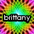 Pixelated text 'brittany' in white lowercase letters on a black rectangular background, set against a colorful pixelated radial gradient of green, yellow, orange, and purple hues.