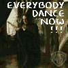 Animated sequence showing a character in dark clothing dancing on stairs with 'EVERYBODY DANCE NOW!!!' text overlay and Warner Bros logo.