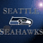 A split-screen buddy icon with a Seattle Seahawks logo on the left and green text reading "Seahawks kick ass" on the right against blue backgrounds.