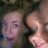 Two pixelated faces in close proximity, one with light hair and the other with darker hair, against a dark background.