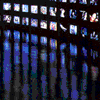 small square images arranged in and on a dark background, with one central image showing a silhouette figure holding an object