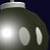 A pixelated spherical object with two oval eyes and a rounded top against a dark background.