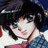 A pixelated contact sheet showing two frames of an animated AIM buddy icon featuring a character with dark hair and a blue checkered shirt on the left, alongside text reading "Anime IM" and "cDM" on a black background.