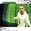 A person in white clothing against a green background with repeated 'JUSTIFIED' text in green and black pixelated borders