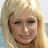 A pixelated image of a person with long blonde hair on a light blue background, with repeated text elements in pink.