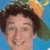 Pixelated image of a person with brown hair wearing an orange and green hat against blue background, next to yellow text on light blue.