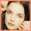 Four- showing close-up facial features and the name 'Katie' in pixelated text on a peach background