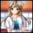 Pixelated anime-style character with long brown hair and red eyes, wearing a white shirt with a blue graphic, standing against a blurred indoor background.