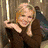 A static image shows a woman with blonde hair in three : left she smiles and holds her head, middle has green and blue elements behind her, right she crosses arms in black top