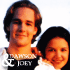 Two people pose closely together with one arm around the other's shoulder, smiling against a bright background.