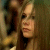 Two side-by-side show a person with long brown hair in different poses, with pixelated text below reading "I DON'T KNOW WHO YOU ARE BUT I'M WITH YOU"
