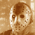 Static pixelated image of a hockey mask with brown and white tones on a beige background, resembling Jason Voorhees from Friday the 13th.