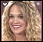 Animated contact sheet of a celebrity with curly blonde hair showing sequential text changes from 'Carrie' to 'Carrie Your Tractor 15 Sexy' across multiple frames, each frame containing a heart symbol in the top-left corner.
