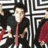 Pixelated image of a person in dark clothing with red accents against a white maze-like background, alongside green and white skull graphics on black.