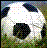 Pixelated soccer ball with black and white sections on a green field background, featuring scattered colored dots.