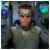 Pixelated static image of a person with light brown hair wearing a gray shirt against a dark background with blue and green pixel clusters.
