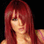 A pixelated image of a person with long red hair in three poses against black and green backgrounds, wearing a purple sleeveless top.