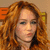 A pixelated image of a person with long wavy red hair, blue eyes, and light skin in three sequential poses showing slight head movement.