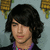 A person with dark wavy hair and a purple shirt appears in three views with subtle facial expression changes against a light blue background with yellow shapes.