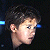 A 50x50 pixel buddy icon split into two frames showing a person's profile on the left and green text 'Original Icons .com' on the right against dark backgrounds.