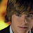 A 48x48 pixel buddy icon featuring a split composition with a person's face on the left and stylized text on an orange background on the right.