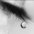 Black-and-white close-up of a tear falling from an eye, paired with pixelated text asking if this is what love looks like because it doesn't seem fun.