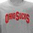 A gray t-shirt with red text on a blue background, accompanied by yellow pixelated text explaining the shirt's significance.