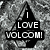 Black triangular shape with white text "I LOVE VOLCOM!" on a pixelated gray background.