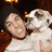A pixelated image shows a person in a white shirt holding a white dog with dark patches, next to blue text reading "what a cute couple!" on a black background.