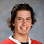 Pixelated portrait of a person with brown hair in a red jersey with white trim, next to pixelated text reading 'Michael', 'Michael Del Zotto', '#4', and '<3' on black and gray backgrounds.