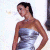 A pixelated image of a woman in a strapless silver dress standing against a light background, with green text reading 'Original Icons .com' on the right side.