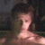A pixelated image of a person with dark hair against a blurred background, next to green text reading 'Original Icons .com' on a solid green backdrop.