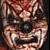 Pixelated static image of a distorted clown face with exaggerated features and dark background elements.