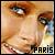 Pixelated close-up of a person's face with brown hair, blue eyes, and light skin tone; text 'PARIS' in black block letters at bottom right.