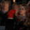A person with brown hair wears a red sleeve and dark clothing, shown in four with subtle facial expression changes