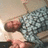 Pixelated image of a figure in motion with blurred limbs against a light background.