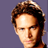 Static 48x48 pixel icon showing a close-up of a person's head and shoulders with brown hair against a solid purple background, rendered in low-resolution pixel art style.