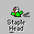 Pixelated character with green jacket, red and gray head, and brown object, below text reading "Staple Head" on gray background.