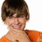 Pixelated close-up of a person with short brown hair wearing an orange shirt against a white background.