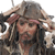 Pixelated image of a person with long dark hair wearing a wide-brimmed hat and dark clothing, holding a sword-like object near their face.