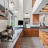 Pixelated static image showing indistinct interior space with brown and gray tones, a black square element, and blurred architectural details.