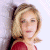 A pixelated image of a person with blonde hair wearing red clothing against a light background, next to green text reading 'Original Icons .com' on dark green.