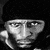 Black-and-white pixelated image of a person with hand near face and motivational quote text in white block letters on black background.