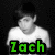 A black-and-white image of a person in a white shirt with green text reading "Zach" overlaid, showing motion blur