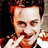 Pixelated image of a person with short brown hair and light skin, wearing a white shirt with red accents, positioned next to black background text reading "In Tyler We Trust".