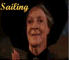 Animated sequence showing four with characters and text: 'Sailing' in yellow script, a woman in black attire, 'in' in yellow script, an elderly man with long white hair and beard, 'McDumbledore Land' on red fabric background, and two figures at a table