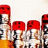 Animated sequence of red-capped figures with yellow lower bodies, silver upper bodies, and black-and-white checkered patterns, arranged in a against a light background