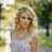 A woman with blonde hair in a white sleeveless top stands outdoors; red text 'love story' appears on the right side of the image.