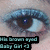 A pixelated close-up of a human eye with blue and brown tones, featuring visible text overlay in teal-colored block letters on black background.