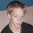 Pixelated image of a person with light brown hair wearing black clothing against blue and beige background, split into four quadrants with text overlays.